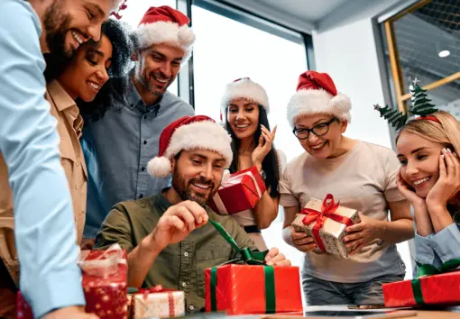 a team opening gifts at the office