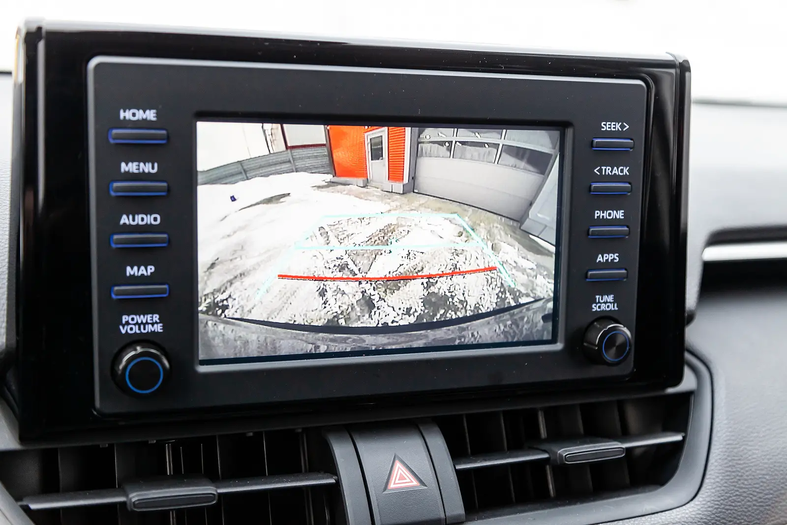 Display of the multimedia system on the car dashboard with an image from the rear view camera for safe reversing.