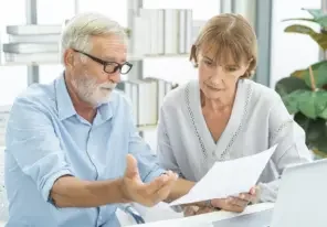 an older man and woman planning for retirement