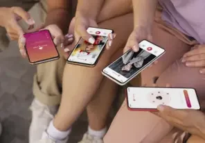 a group of young individuals using apps on their phones