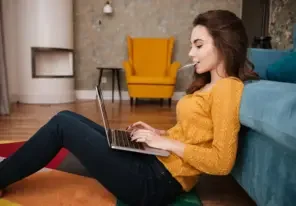 a woman using her credit card while on her laptop