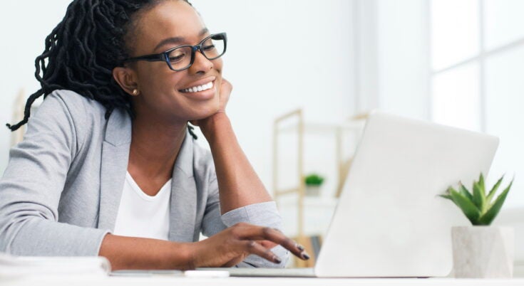 a business owner smiling at positive online reviews