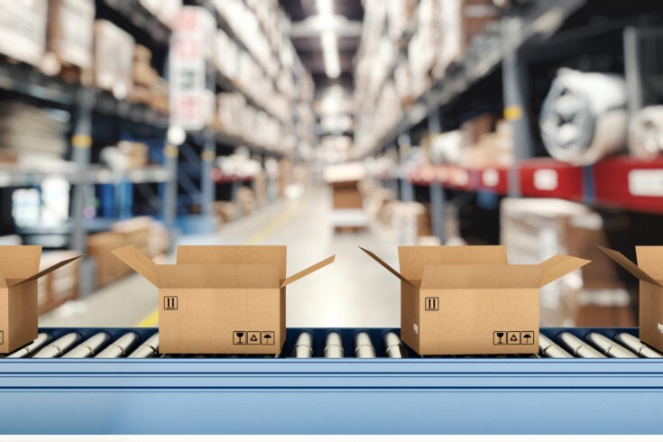 open shipping boxes on a conveyor belt