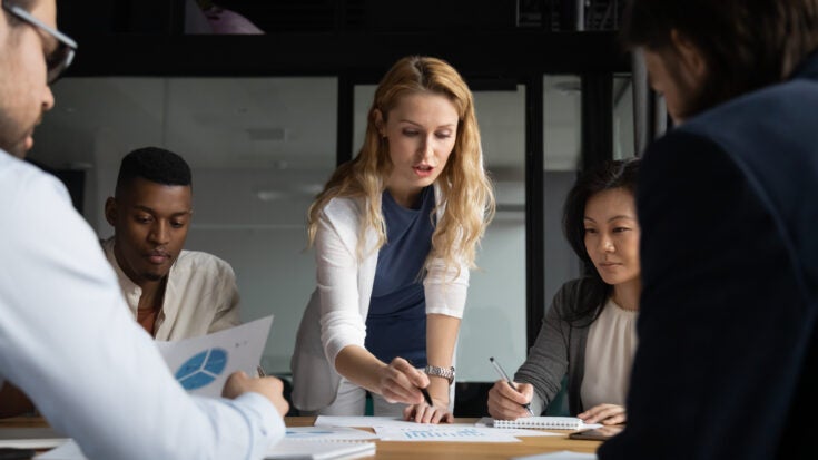 a team of business people reviewing market research