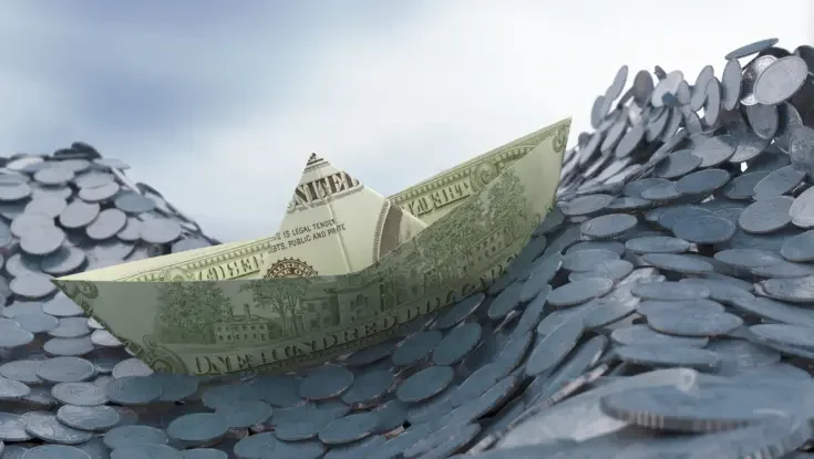 a stylized photo of a boat made of money navigating waves of coins
