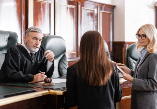 a judge listens to two lawyers