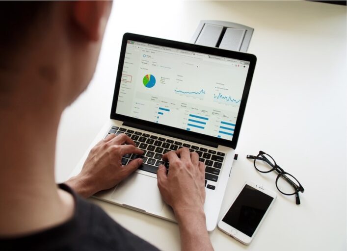 a person using an analytics program analyzing financial data