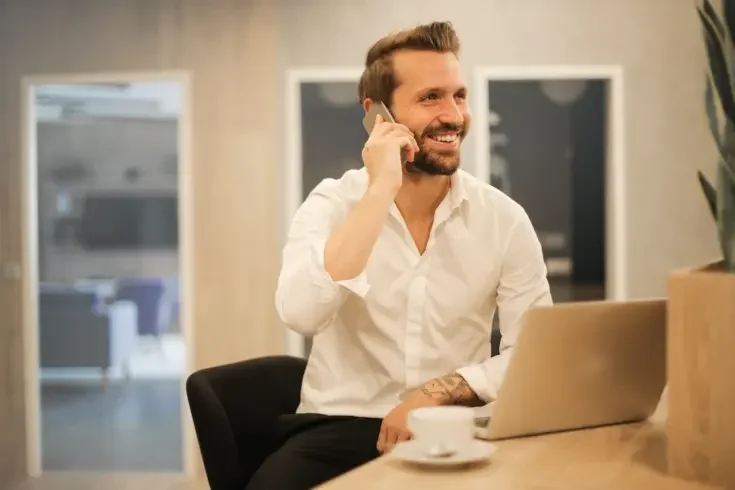 a business owner smiling on the phone