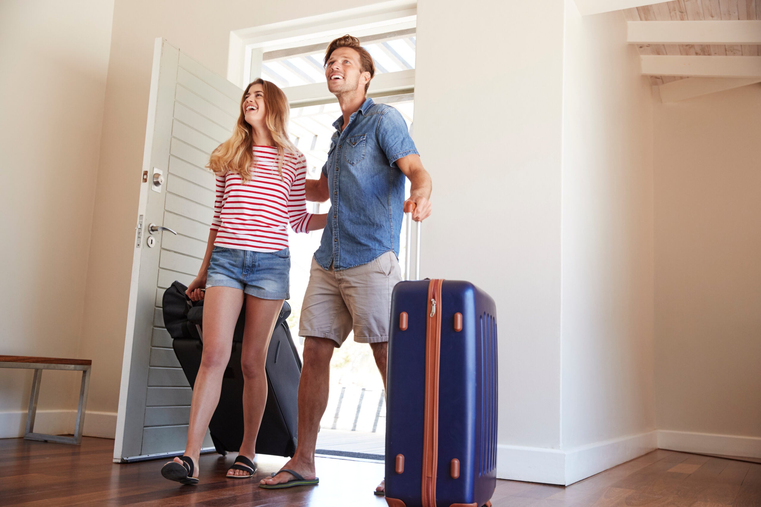 Couple Arriving At Summer Vacation Rental