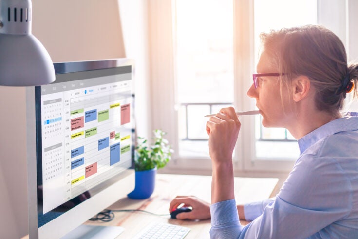 a person using scheduling software to manage events