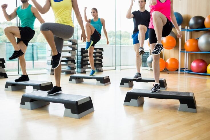 a fitness class exercising in a studio