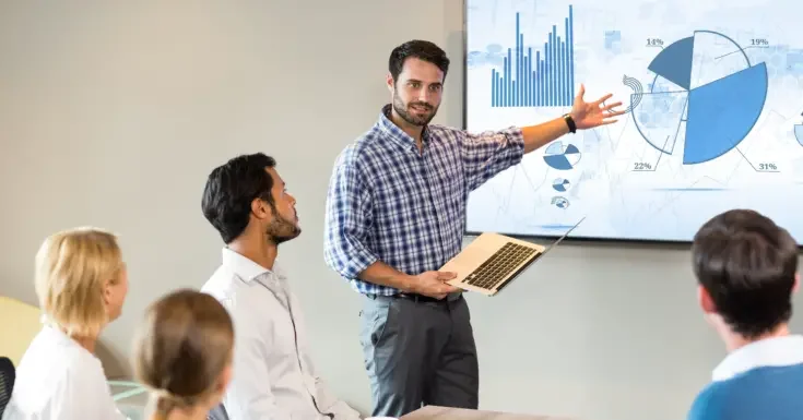 A team member presenting data to their team
