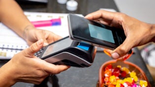 a man paying via contactless payments in mobile phone