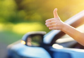 a thumbs up outside of a car window