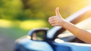 a thumbs up outside of a car window