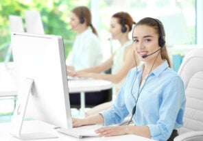 Young female sales support dispatcher working in office