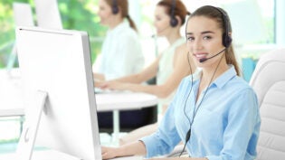 Young female sales support dispatcher working in office