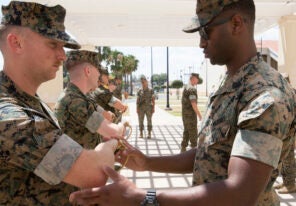A U.S. Marine with Special Purpose Marine Air-Ground Task Force-Crisis Response-Africa 19.2, Marine Forces Europe and Africa, instructs a student on a proper draw technique of noncommissioned officer sword during Corporals Course at the Naval Air Station Sigonella, Sicily, Italy, July 17, 2019. The Marines and a Sailor with SPMAGTF-CR-AF 19.2 participated in the course that consisted of classes on land navigation, sword and guidon manual, and development of mentorship and leadership skills. SPMAGTF-CR-AF is deployed to conduct crisis-response and theater-security operations in Africa and promote regional stability by conducting military-to-military training exercises throughout Europe and Africa. (U.S. Marine Corps photo by Staff Sgt. Mark E. Morrow Jr.)