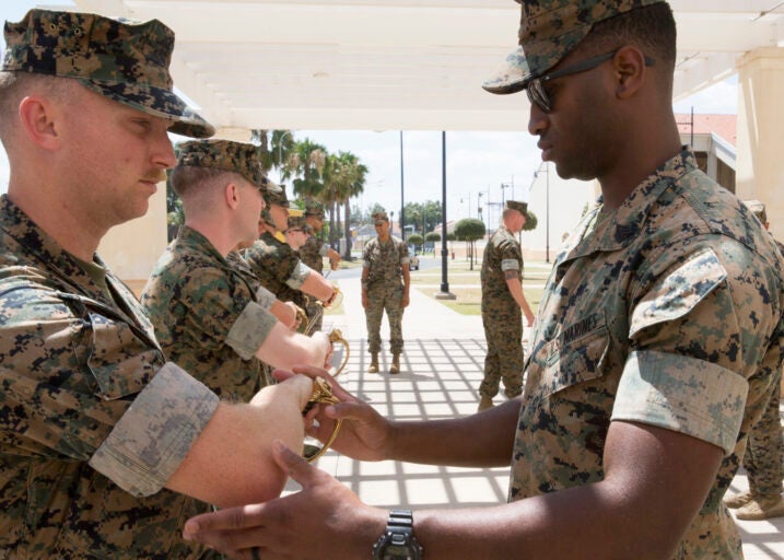 A U.S. Marine with Special Purpose Marine Air-Ground Task Force-Crisis Response-Africa 19.2, Marine Forces Europe and Africa, instructs a student on a proper draw technique of noncommissioned officer sword during Corporals Course at the Naval Air Station Sigonella, Sicily, Italy, July 17, 2019. The Marines and a Sailor with SPMAGTF-CR-AF 19.2 participated in the course that consisted of classes on land navigation, sword and guidon manual, and development of mentorship and leadership skills. SPMAGTF-CR-AF is deployed to conduct crisis-response and theater-security operations in Africa and promote regional stability by conducting military-to-military training exercises throughout Europe and Africa. (U.S. Marine Corps photo by Staff Sgt. Mark E. Morrow Jr.)