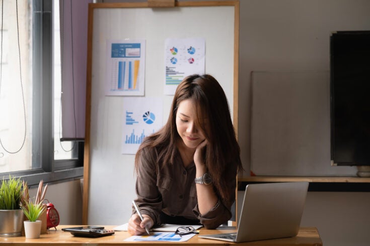 Businesswoman or Accountant hands holding paperwork with calculator, account and saving concept.
