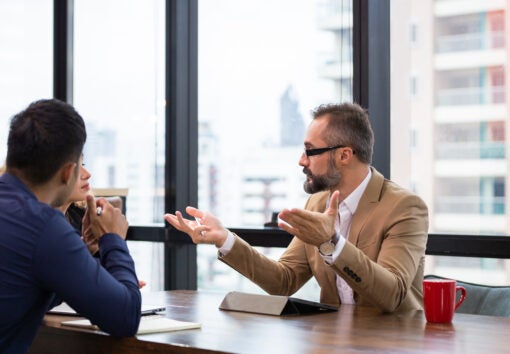 Caucasian male manager explaining work project to colleagues in a meeting room at the office. group of business financial discussing project and working together