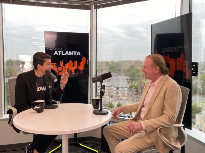 Two professional men talking in a podcast studio