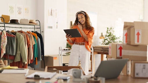 woman checking ipad in clothing store