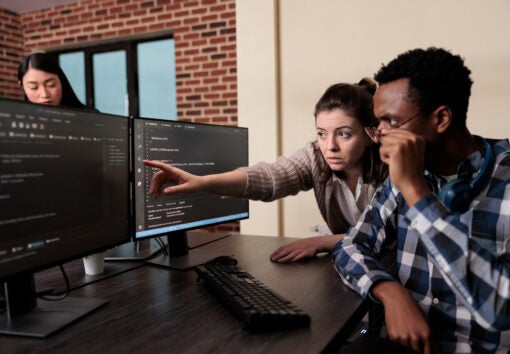 Caucasian software developer signaling on screen data breach and deactivated security system. Tech engineer observing multiple system security breaches caused by overloaded storage servers.