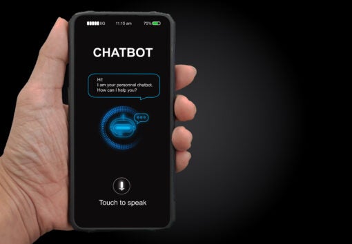 A man's hand holding mobile smartphone with chatterbot application for online information. Digital chatbot, conversational agents, robot app, conversation assistant. AI Artificial intelligence concept