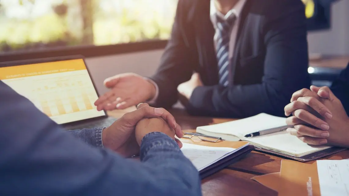 two men looking at a contract