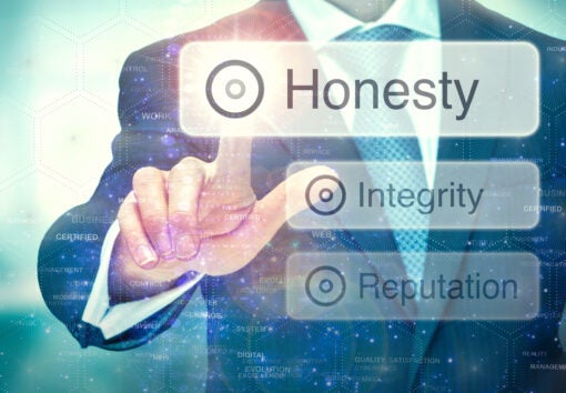 A business man selection a button on a futuristic display with a Honesty concept written on it.