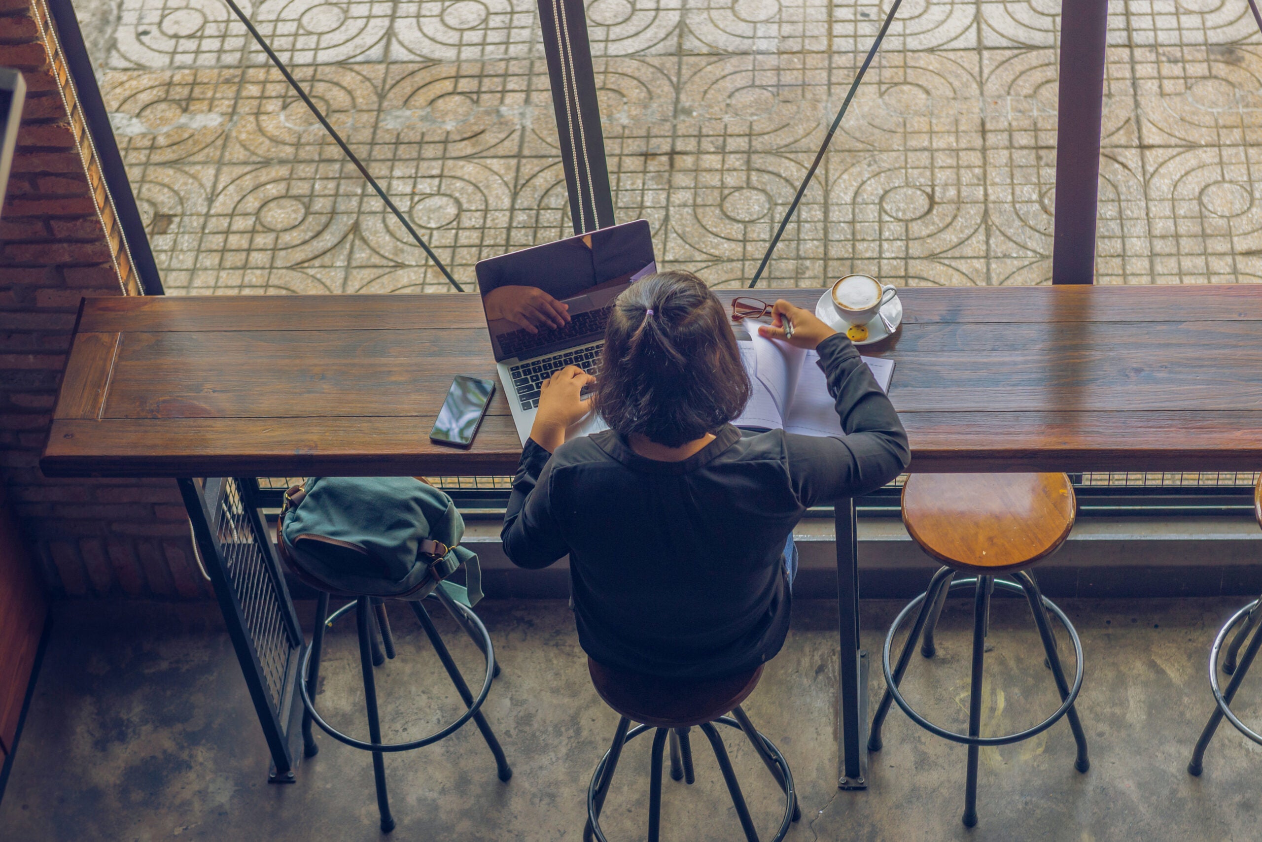 High angle view of woman freelancer working on laptop