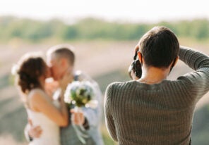 wedding photographer takes pictures of the bride and groom in nature in autumn, the photographer in action