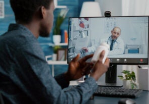 Black man at home seeking medical help from doctor via online intenet telehealth consultation with family doctor. Health care checkup via video virtual conference, patient looking for medicine advice