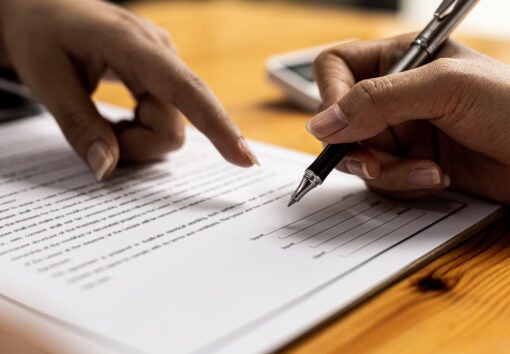 Two people are doing corrupt behavior, they are mutual business partners and are signing contracts to receive bribes for mutual benefit. The concept of business fraud and bribery is illegal.