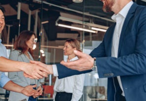 Men are shaking their hands in modern office