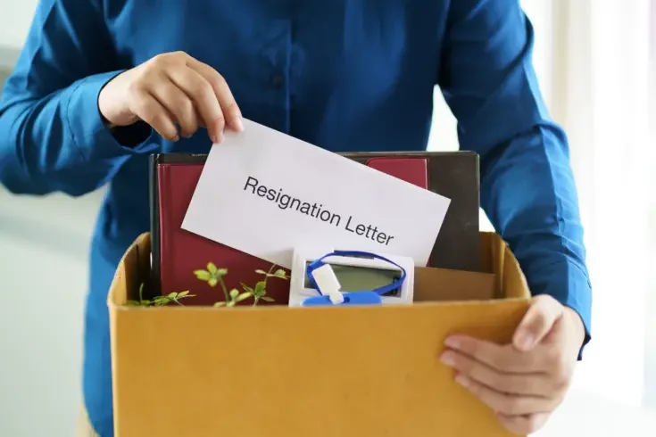 Business man sending resignation letter and packing Stuff Resign Depress or carrying business cardboard box in office. Change of job or fired from company