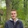 Headshot of young man in forest