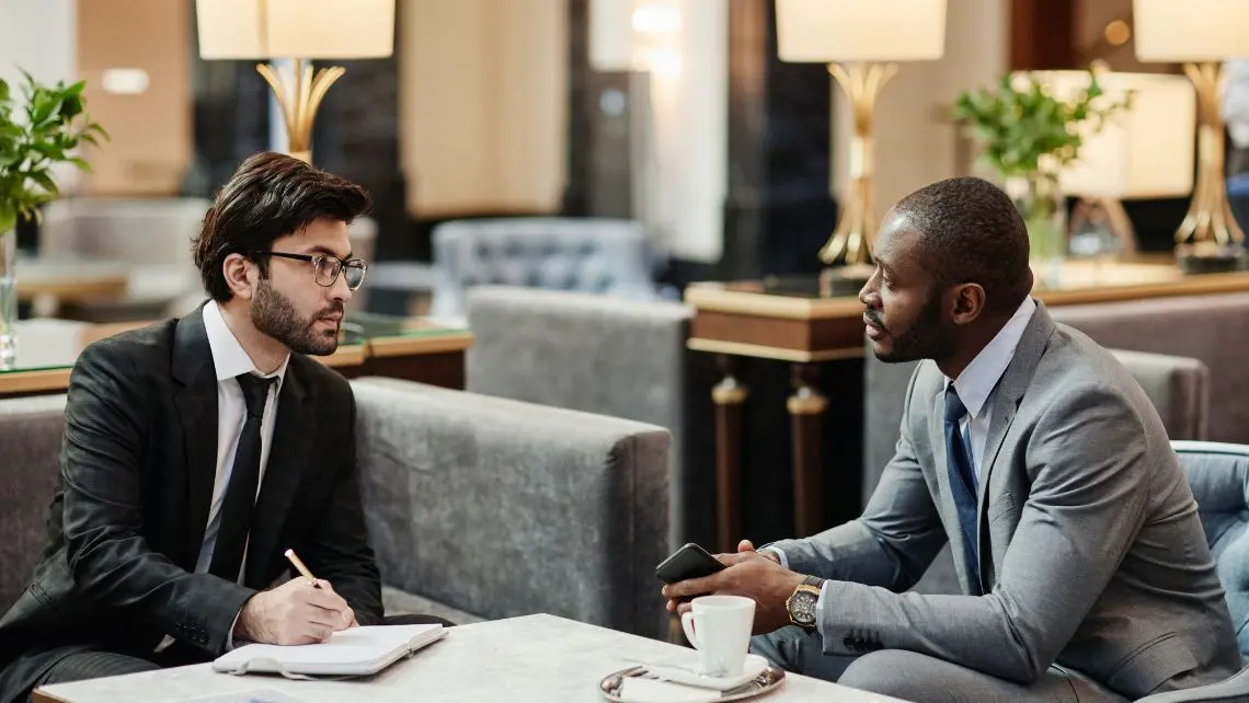 two men having coffee in luxury restaurant