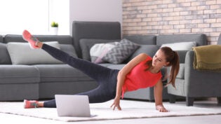 young woman doing fitness exercise at home