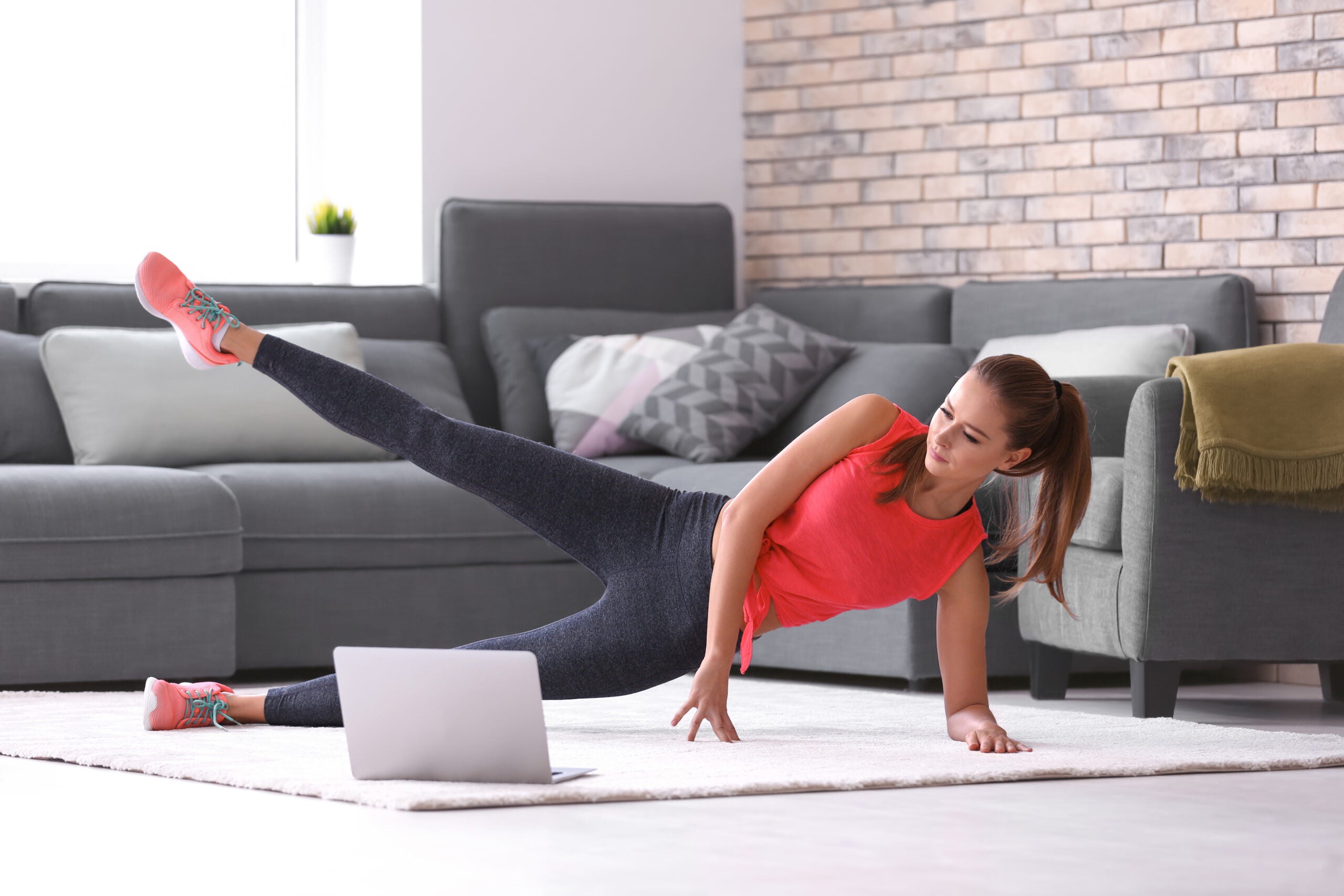 young woman doing fitness exercise at home