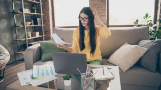 Doubtful uncertain female marketer holding document trying to find startup solution