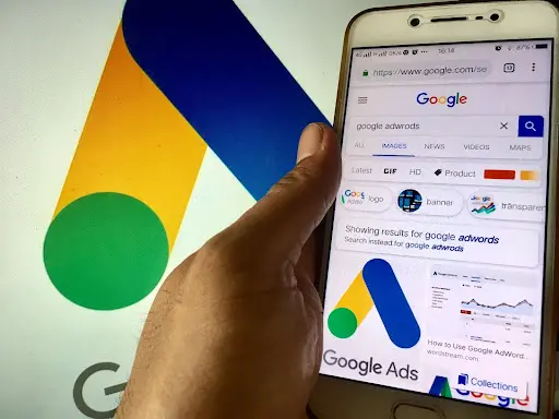 hand holding phone showing google ads