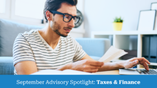 Young man with glasses reviewing bills