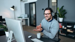 Young man having online call at modern office.