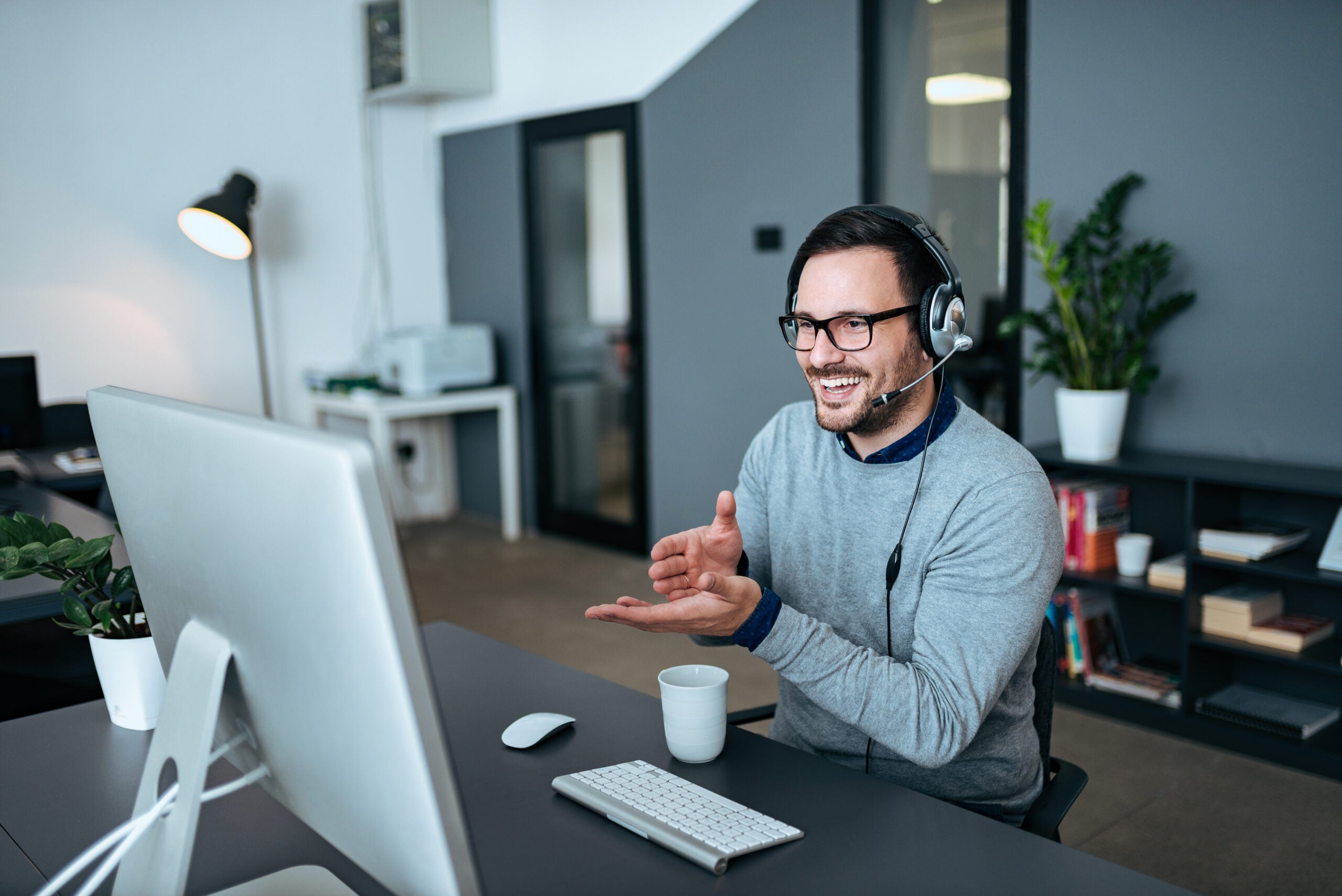 Young man having online call at modern office.