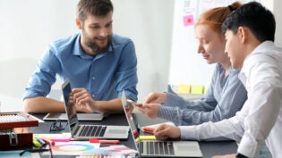 Young IT designers working in office