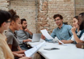 Group of young business people discussing something while working together in the creative office.