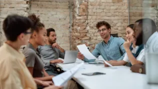 Group of young business people discussing something while working together in the creative office.