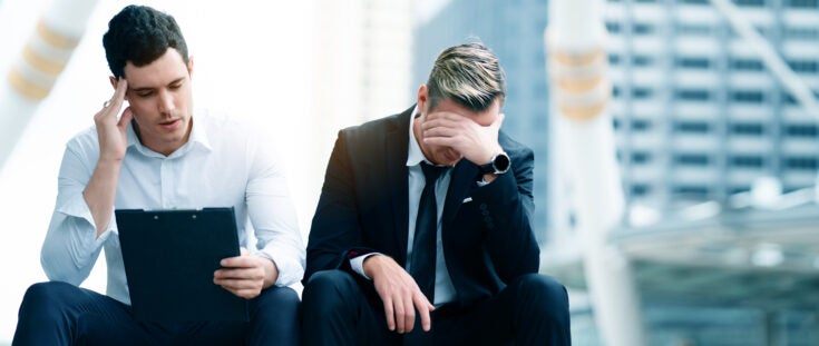 2 businessmen under Stress caused by the economic issues